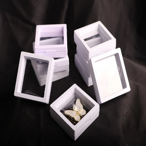 White PE film floating jewelry display boxes on black fabric for storage and organization
