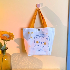 Minimalist canvas tote bag with blue cartoon bear and yellow nice print on the front