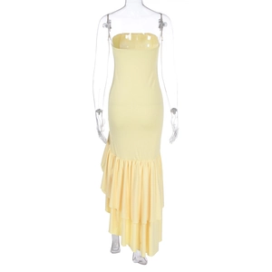 Detail of light yellow tube dress showing asymmetric tiered ruffle hem on the back