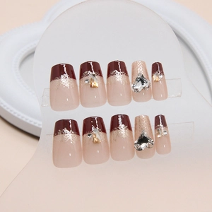 Burgundy and nude pink press-on nails with heart rhinestones and glitter gradient