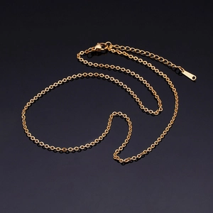 Gold stainless steel O-chain necklace with extender on a reflective black background