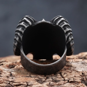 Vintage ram skull head ring in antique silver finish for men on wood background