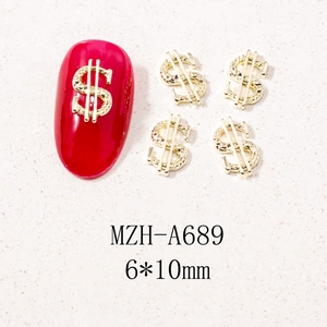 Macro shot of gold dollar sign metal nail charms with detailed 3D texture for nail art DIY