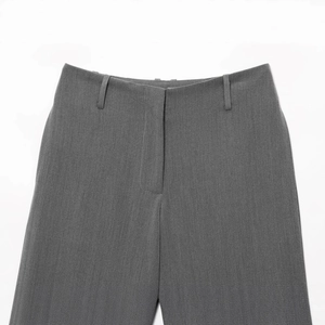 Front waist detail of grey casual long tailored trousers with visible fabric texture