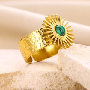 Detail of vintage gold titanium ring with turquoise stone inlay and sunburst engraving