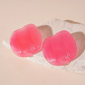 Pink translucent resin earrings with vertical stripes on a minimalist beige stone pedestal