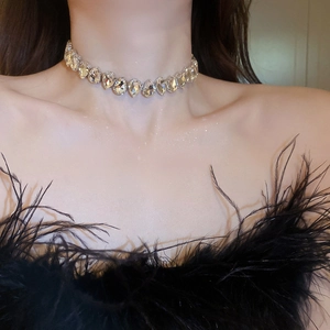 Close-up of sparkling waterdrop crystal choker necklace on a model in evening dress