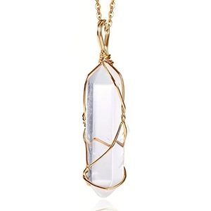 Detail of hand-wrapped hexagonal clear crystal pendant with gold wire on chain