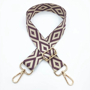 Detail of adjustable purple rhombus pattern woven strap with gold metal lobster clasps