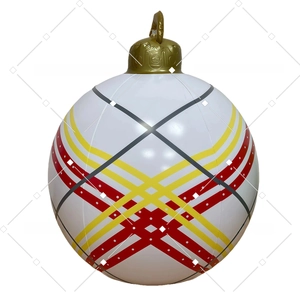 Close-up of inflatable Christmas ball with red and yellow stripes and gold top cap