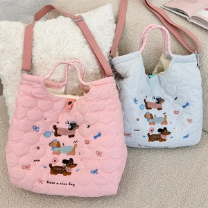 Detailed close-up of quilted polyester bags with cute dachshund embroidery and textures