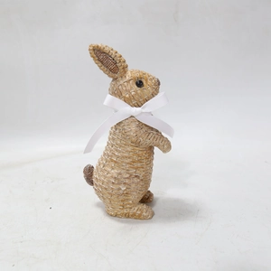 Detail of resin rabbit ornament with woven texture and a white ribbon bow decor