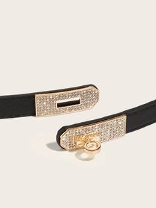 Detail of lychee pattern leather belt with a luxury gold rhinestone-encrusted turn-lock