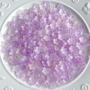 Detail of purple gradient resin flower beads with gold foil flakes for DIY jewelry crafts