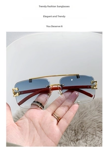 Detail of square pilot sunglasses with gradient blue lenses and wood grain temples