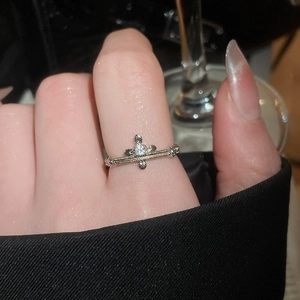 Macro view of French zircon ring with cross design and clear crystal on a hand