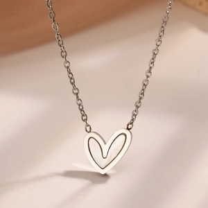 Detail of heart necklace with white mother of pearl inlay on fine silver steel chain