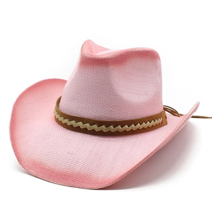 Pink western straw cowboy hat with brown braided band and wide curved brim on white background