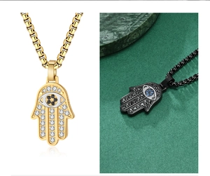 Detail of Hamsa Hand pendants with CZ stones and Evil Eye in gold and black finishes