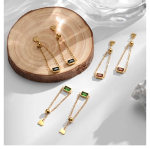 Detail of adjustable chain rings with emerald, ruby, and black zircon rectangular gems
