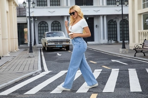 Style de rue d'un jean bleu clair à taille haute et jambe large avec un haut blanc