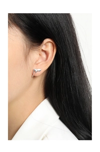 Macro detail of S925 sterling silver stud earrings with liquid lava drop design on model