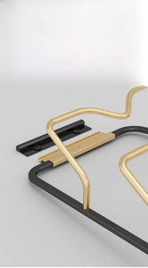 Detail of wall-mounted black and gold metal pot lid rack with detachable design