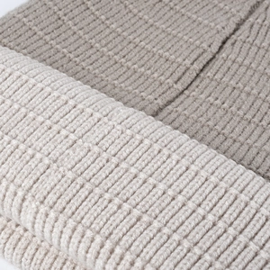 Close-up of beige and coffee thick ribbed knit winter beanie with soft warm texture