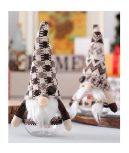 Close-up of two Christmas gnome coffee storage jars with knitted hats and clear bodies