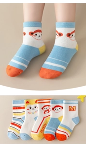 Detail of five pairs of colorful cartoon monkey mid-calf socks for children in soft cotton