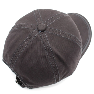 Detail view of cotton baseball cap crown with durable double-stitched seams and top button