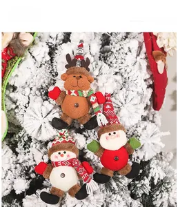 Detail of plush reindeer and snowman ornaments with knitted hats on a flocked Christmas tree