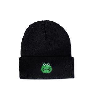 Detail of cute green frog embroidery on the cuff of a black knitted beanie