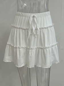 Detail of white tiered cake skirt with elastic waistband and adjustable drawstring tie