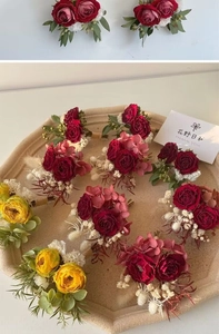 Detailed close-up of handmade boutonniere with roses and hydrangeas on a stone tray