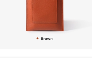Detailed close-up of brown textured leather with fine stitching on a minimalist phone bag