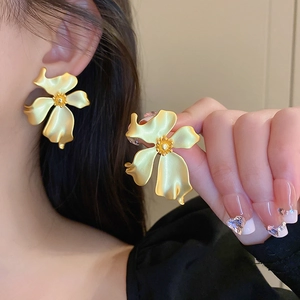 Vintage style matte gold metal flower earrings with textured petals for women