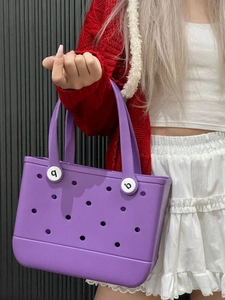 Detail view of purple EVA beach bag with holes showing sturdy handles and rivet hardware
