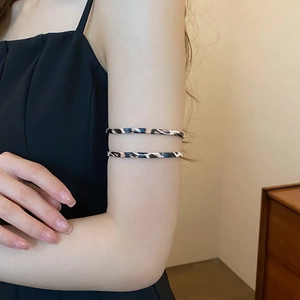 Close-up of leopard print twisted leather armlet showing fine texture and ethnic style