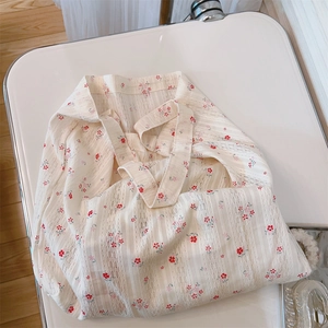 Close-up of floral cotton lace tote bag with blue and red patterns on a white chair