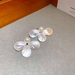 Elegant silver flower stud earrings with mother of pearl petals and a central white pearl