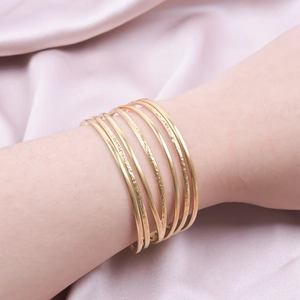 Stackable 18k gold plated titanium steel bangles with hammer texture and smooth finish