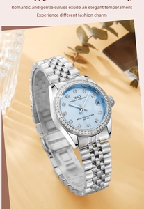 Macro shot of the luxury quartz watch with light blue dial and sparkling diamond bezel