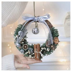 Detailed Christmas wreath with pine needles, dried orange slices, berries and silver bells