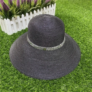 Detail of black wide brim straw hat with silver sequin band and metallic V-logo decoration
