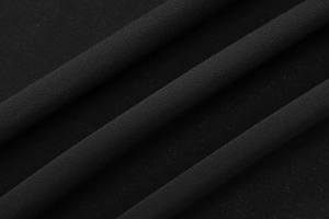 Close-up macro view of black sheer chiffon fabric texture with delicate woven structure