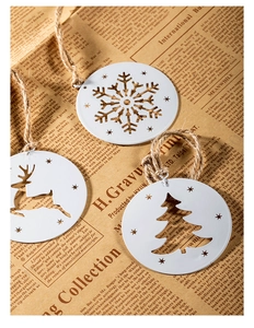 White metal Christmas snowflake and reindeer hanging ornaments on vintage paper