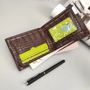 Detail of brown crocodile pattern wallet featuring multiple card slots and photo window
