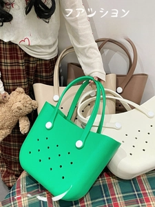 Detail of multi-color EVA beach tote bags with circular hole patterns and top handles