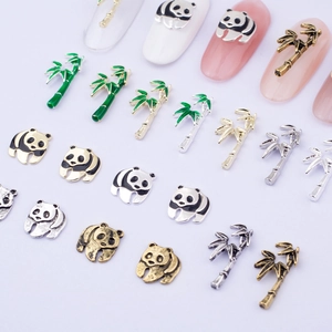 Detailed view of panda and bamboo nail art charms with colorful enamel and metal finishes
